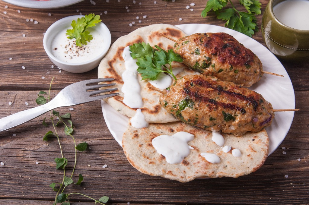 Kofta with flatbread on plate with salad jpg