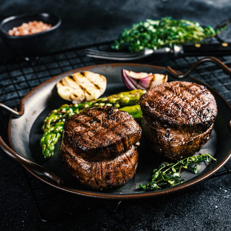 Grilled Fillet Mignon Steak with roasted asparagus. Black backgr